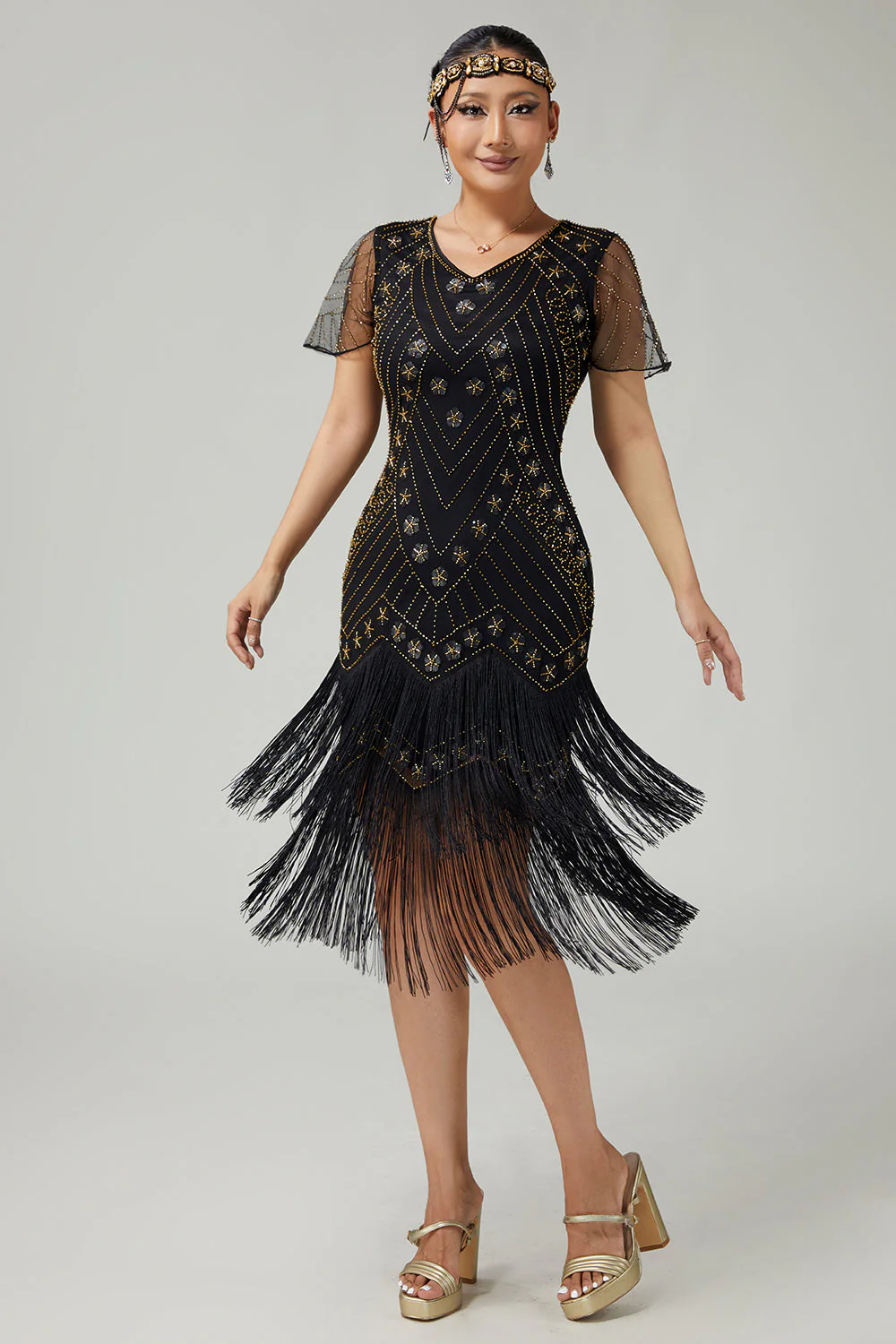 Robe noire dorée à franges des années 1920 avec perles