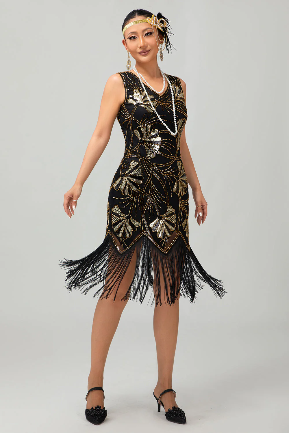 Robe noire scintillante à franges dorées des années 1920